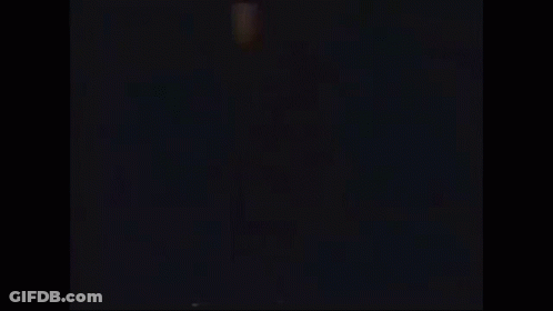 A Silhouette Of A Person Jumping In The Air With Their Arms In The Air . GIF