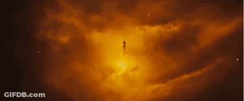 A Silhouette Of A Person Standing In A Dark Cloudy Sky GIF