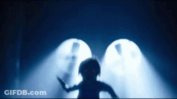 A Silhouette Of A Person Standing In A Dark Room GIF