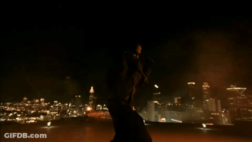 A Silhouette Of A Person Standing In A Dark Room With A Light On The Ground GIF