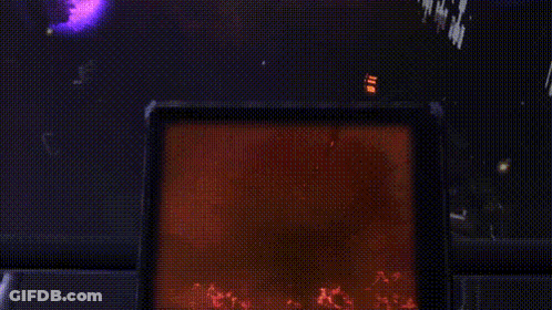 A Silhouette Of A Person Standing In A Dark Room With A Red Light Behind Them GIF