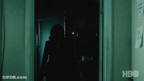 A Silhouette Of A Person Standing In A Dark Room With Hbo Written On The Wall GIF