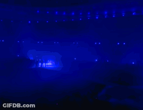 A Silhouette Of A Person Standing In Front Of A Blue And Purple Background GIF