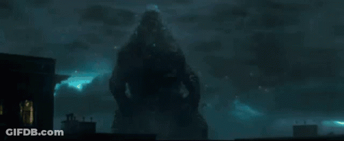 A Silhouette Of A Person Standing In Front Of A Building At Night GIF