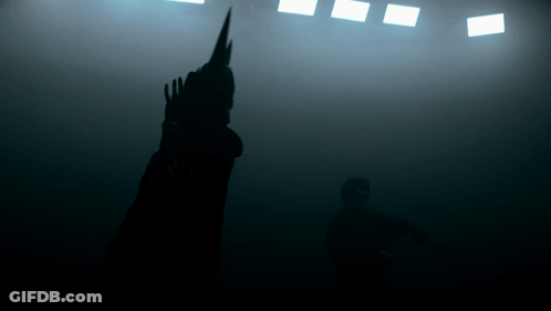 A Silhouette Of A Person Standing In The Dark GIF