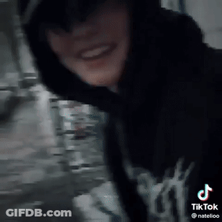 Silhouette Standing In Dark Against White Wall GIF