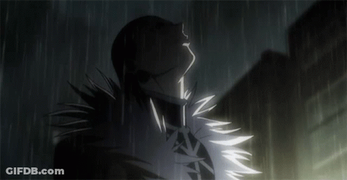A Silhouette Of A Person Standing In The Rain With Their Eyes Closed GIF