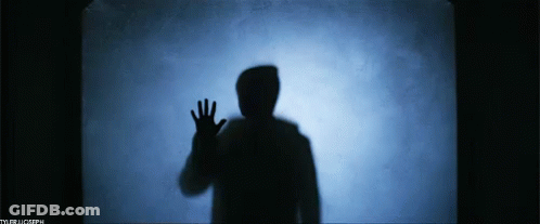 A Silhouette Of A Person Waving Their Hand In Front Of A Blue Background With The Letters Tb On It GIF