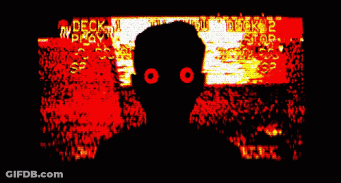 A Silhouette Of A Person With Red Eyes In Front Of A Screen That Says " Deck " GIF
