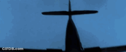 A Silhouette Of A Plane Flying In The Blue Sky GIF