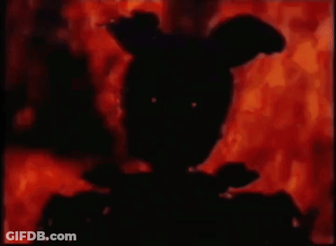 A Silhouette Of A Rabbit Is Standing In Front Of A Fire In A Dark Room . GIF