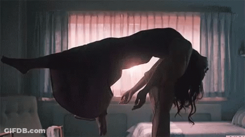 A Silhouette Of A Woman Floating In The Air With A Window Behind Her GIF
