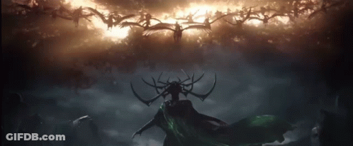 A Silhouette Of A Woman With Antlers Stands In Front Of A Cloudy Sky GIF