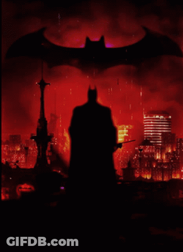 A Silhouette Of Batman Is Against A Red Background GIF
