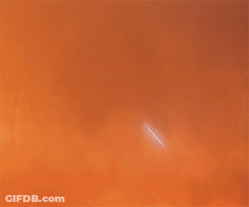 A Silhouette Of Darth Vader Is Standing In Front Of A Fire GIF