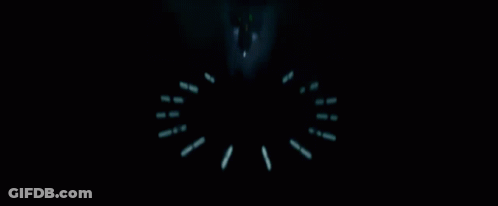 A Silhouette Of Darth Vader Stands In A Dark Room GIF