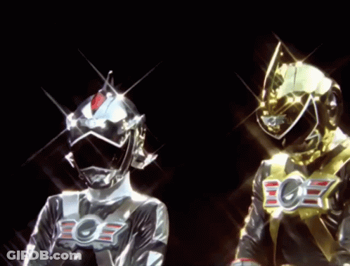 A Silver And A Gold Superhero With The Letter E On Their Chest GIF