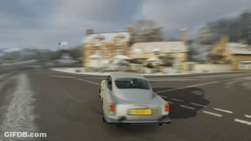 A Silver Car Is Driving Down A Snowy Road With A Yellow License Plate Which Says ' A ' On It GIF