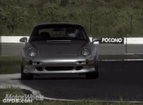 A Silver Car Is Driving On A Road With Motorweek Written On The Bottom Right GIF