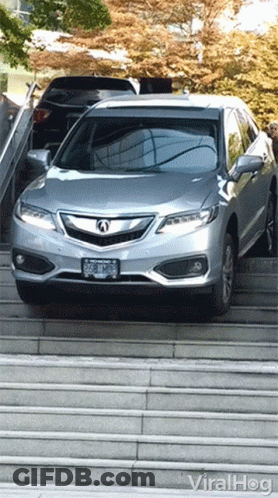 A Silver Car Is Parked On A Set Of Stairs And Says Viralhog On The Bottom Left GIF