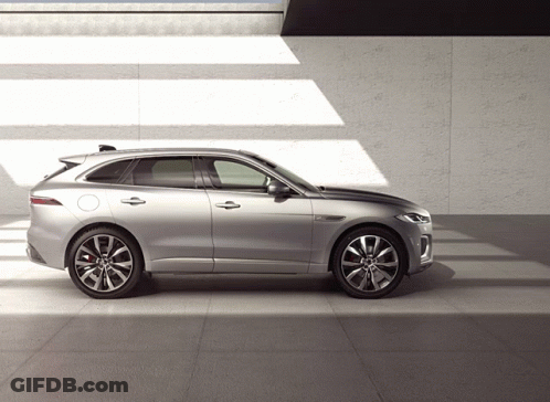 A Silver Car Is Parked On A Tiled Floor In Front Of A Wall GIF