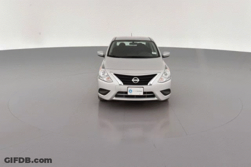 A Silver Car Sits On A Gray Surface GIF