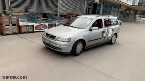 A Silver Car With A Sticker On The Door That Says ' T-Shirt ' On It GIF