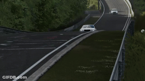 A Silver Chrysler Car Is Driving Down A Track GIF