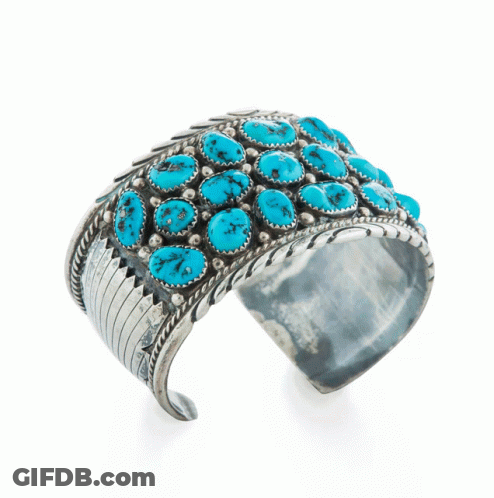 A Silver Cuff Bracelet With Turquoise Stones On A White Background GIF