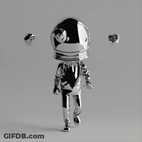 A Silver Figurine Of An Astronaut With A Helmet On GIF