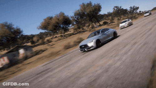 A Silver Infiniti Car Is Driving Down A Road GIF