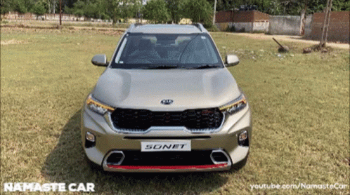 A Silver Kia Sonet Is Parked In The Grass GIF