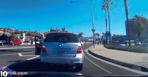 A Silver Mercedes With A California License Plate Is Driving Down The Street GIF