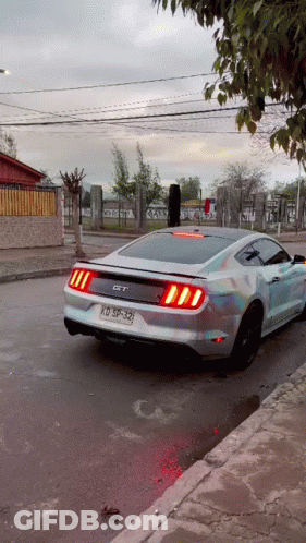 A Silver Mustang With The License Plate Kd Sp-329 GIF