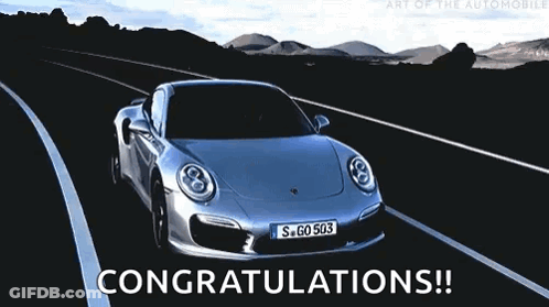 A Silver Porsche Is Driving Down A Road With The Words Congratulations Written Below It GIF