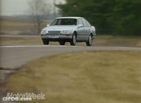 A Silver Sedan With A License Plate That Says Senator Cc Is Driving Down A Road GIF