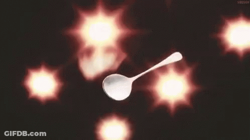 A Silver Spoon Is Floating In The Air In Front Of A Bunch Of Red Lights . GIF