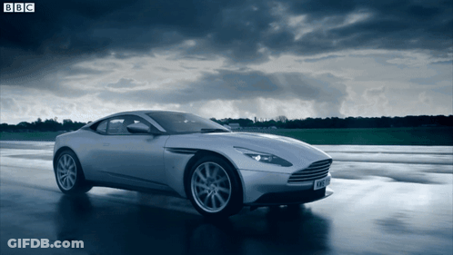 A Silver Sports Car Is Driving On A Wet Road With Bbc Written On The Bottom GIF