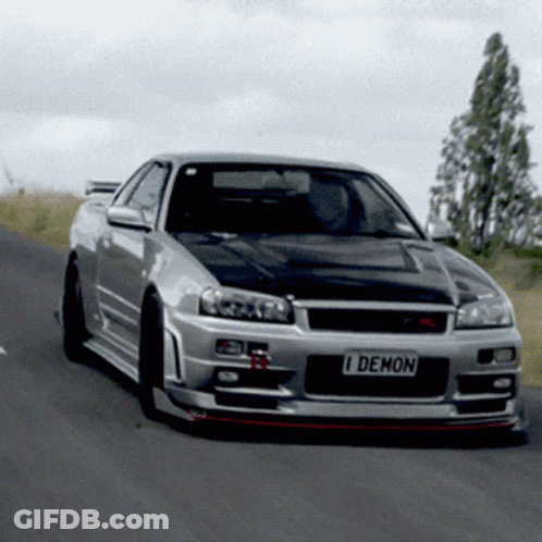 A Silver Sports Car With A License Plate That Says I Demon GIF