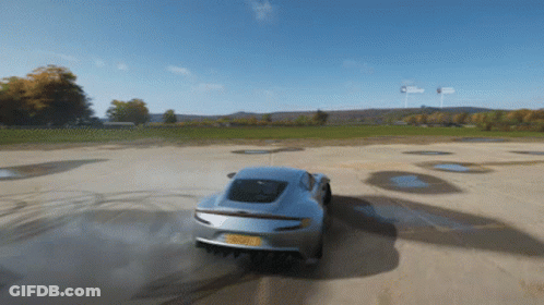 A Silver Sports Car With A License Plate That Says ' Rsc ' On It Is Driving Down A Dirt Road GIF