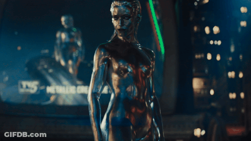 A Silver Statue Of A Woman With A Blue Eye GIF