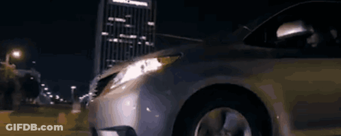 A Silver Van Is Parked In Front Of A House At Night GIF