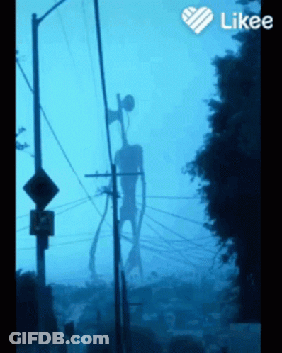 A Siren Head Is Silhouetted Against A Blue Sky Behind Telephone Poles GIF