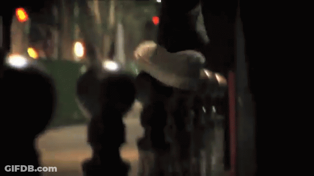 A Skateboarder Is Doing A Trick In Front Of A Bridge GIF