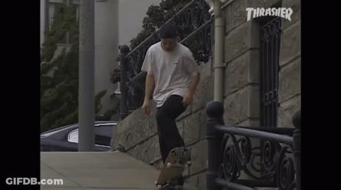 A Skateboarder Is Doing A Trick In Front Of A Building With Thrasher Written On It GIF
