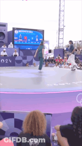 A Skateboarder Is Doing A Trick In Front Of A Crowd At A Competition GIF