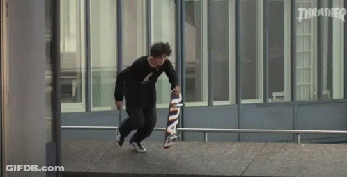 A Skateboarder Is Doing A Trick On A Railing While Holding A Skateboard . GIF