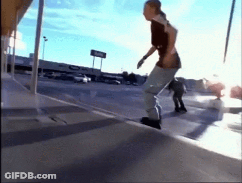 A Skateboarder Is Doing A Trick On A Sidewalk In Front Of A Store That Says Coke GIF