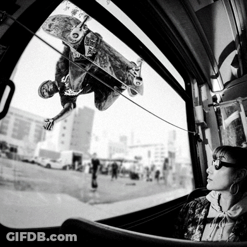 A Skateboarder Is Doing A Trick While Wearing A Shirt That Says Vans On The Front GIF