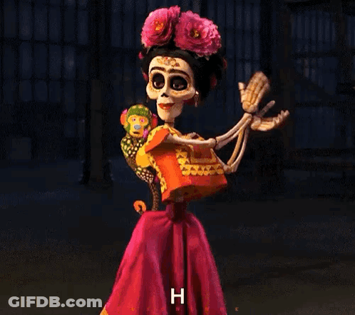 A Skeleton Dressed As Frida Kahlo Is Holding A Stuffed Animal And Giving A Thumbs Up . GIF